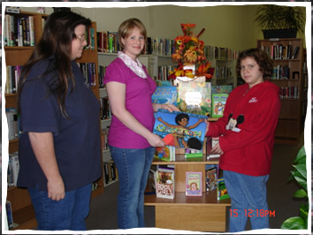 Members of the local Church of Christ donate several Children's books to the library.